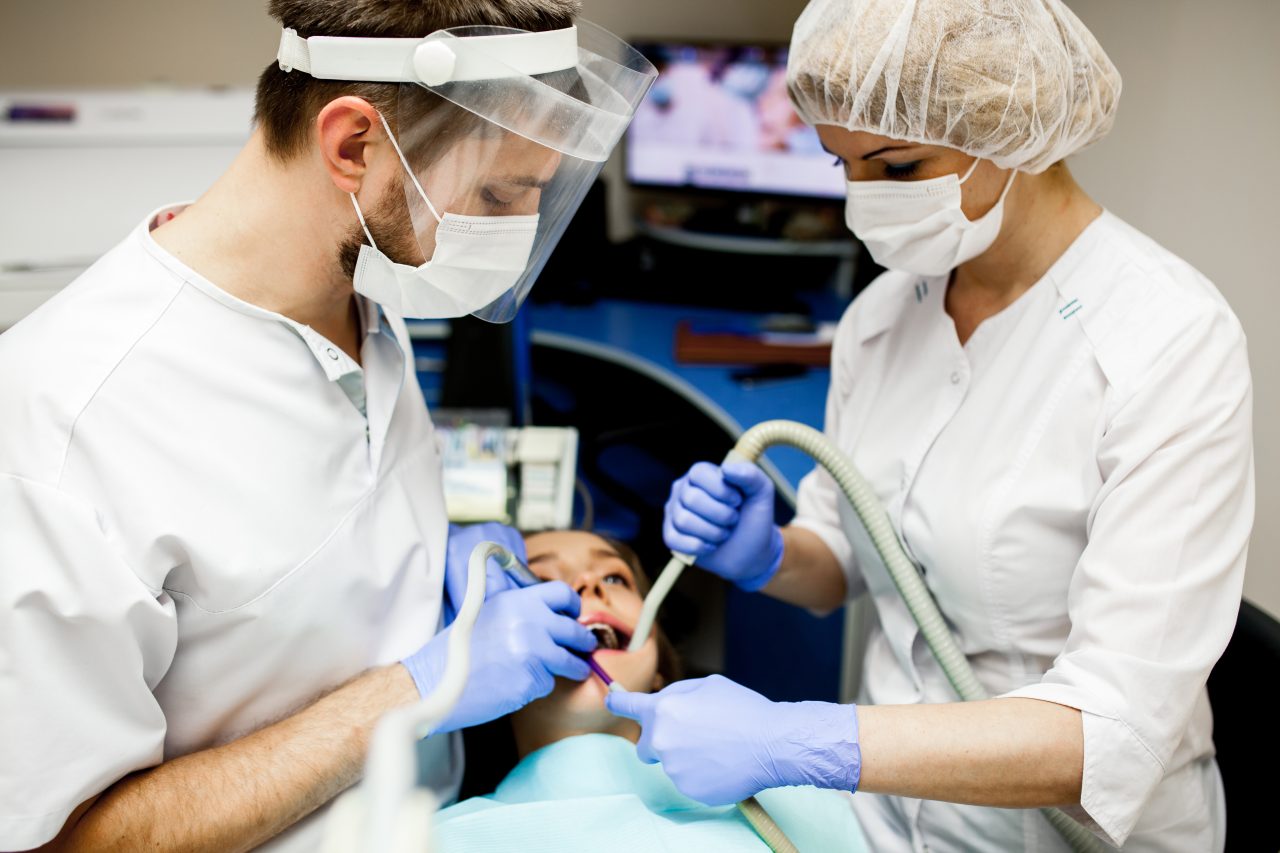 dentistas fazendo tratamento em paciente