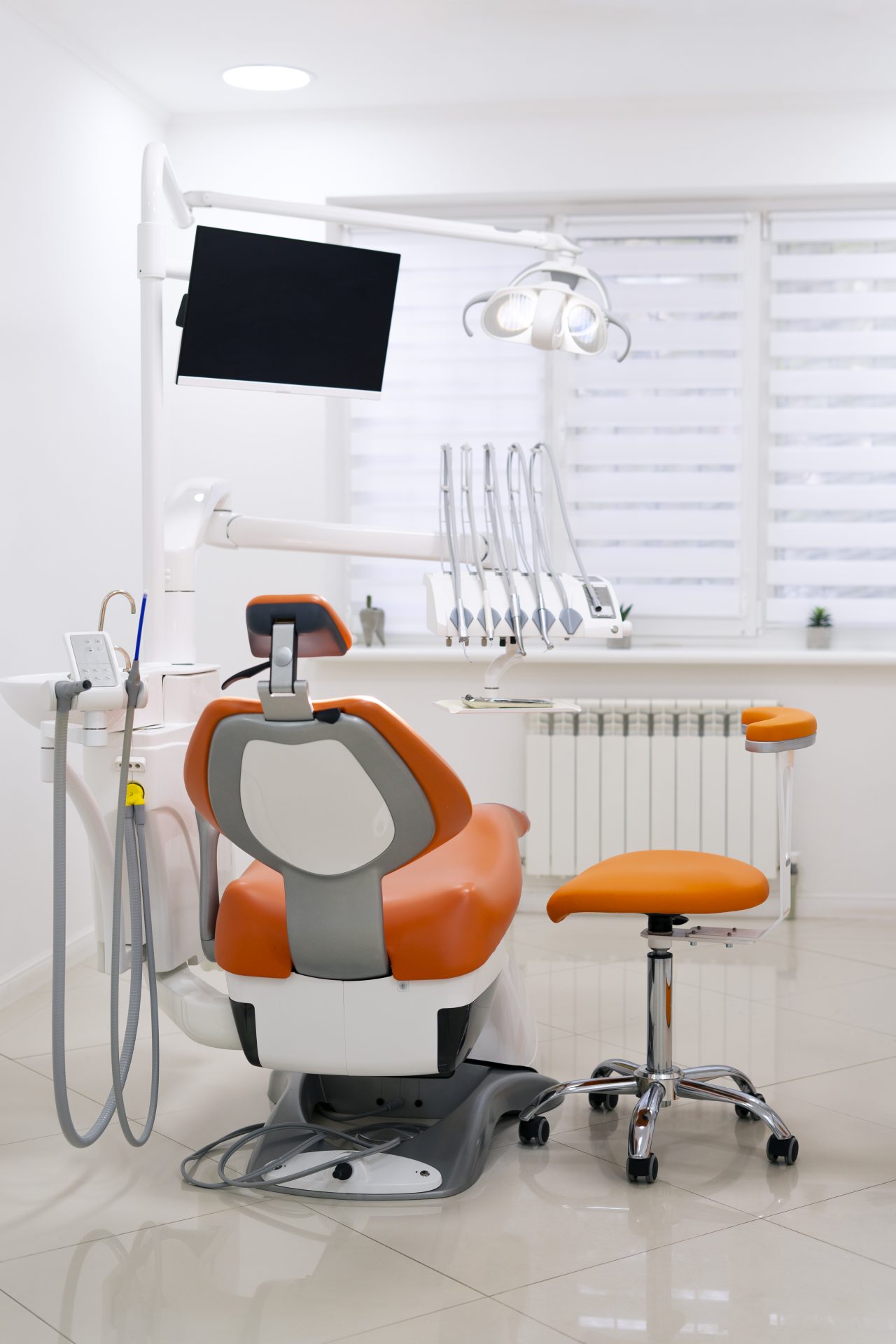 Cadeira odontológica laranja no consultório 