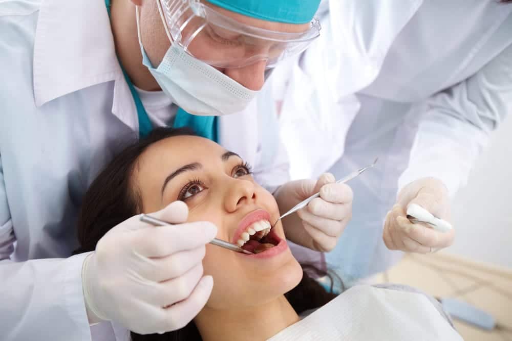 Dentista analisando boca de paciente