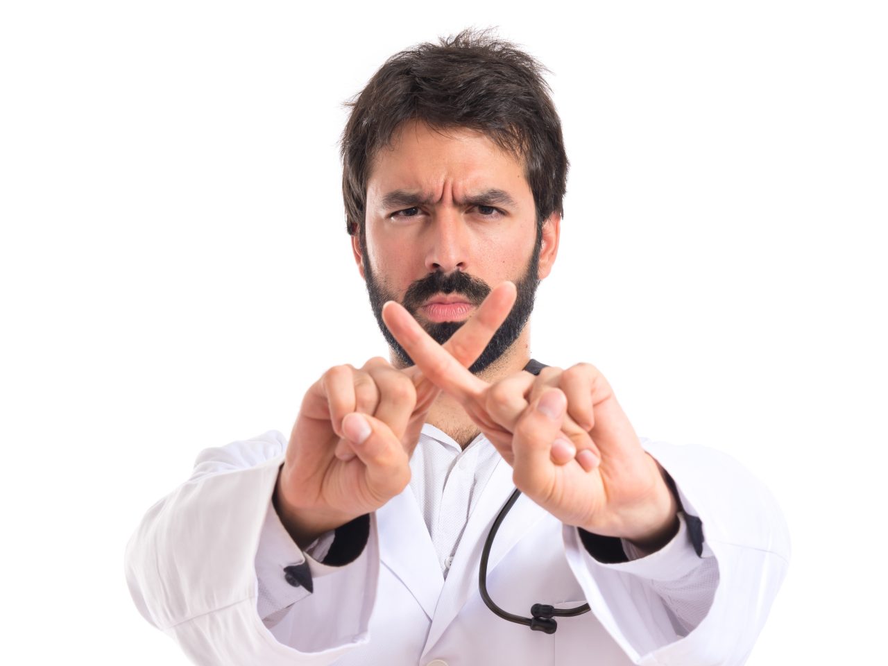 Dentista com rosto sério fazendo não "x" com os dedos.