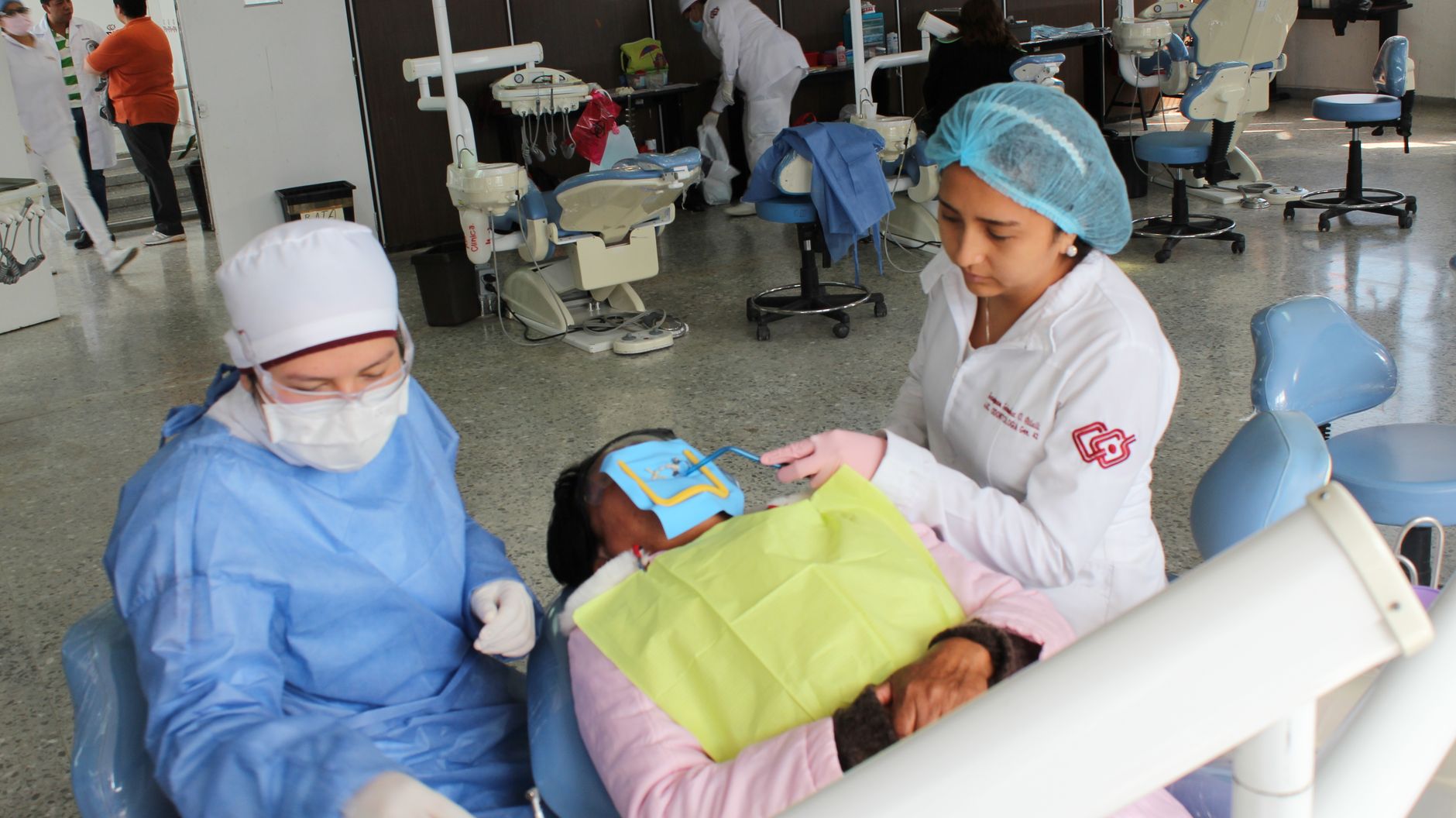 Dentists working on a patient during a dental procedure in a modern clinic setting.
